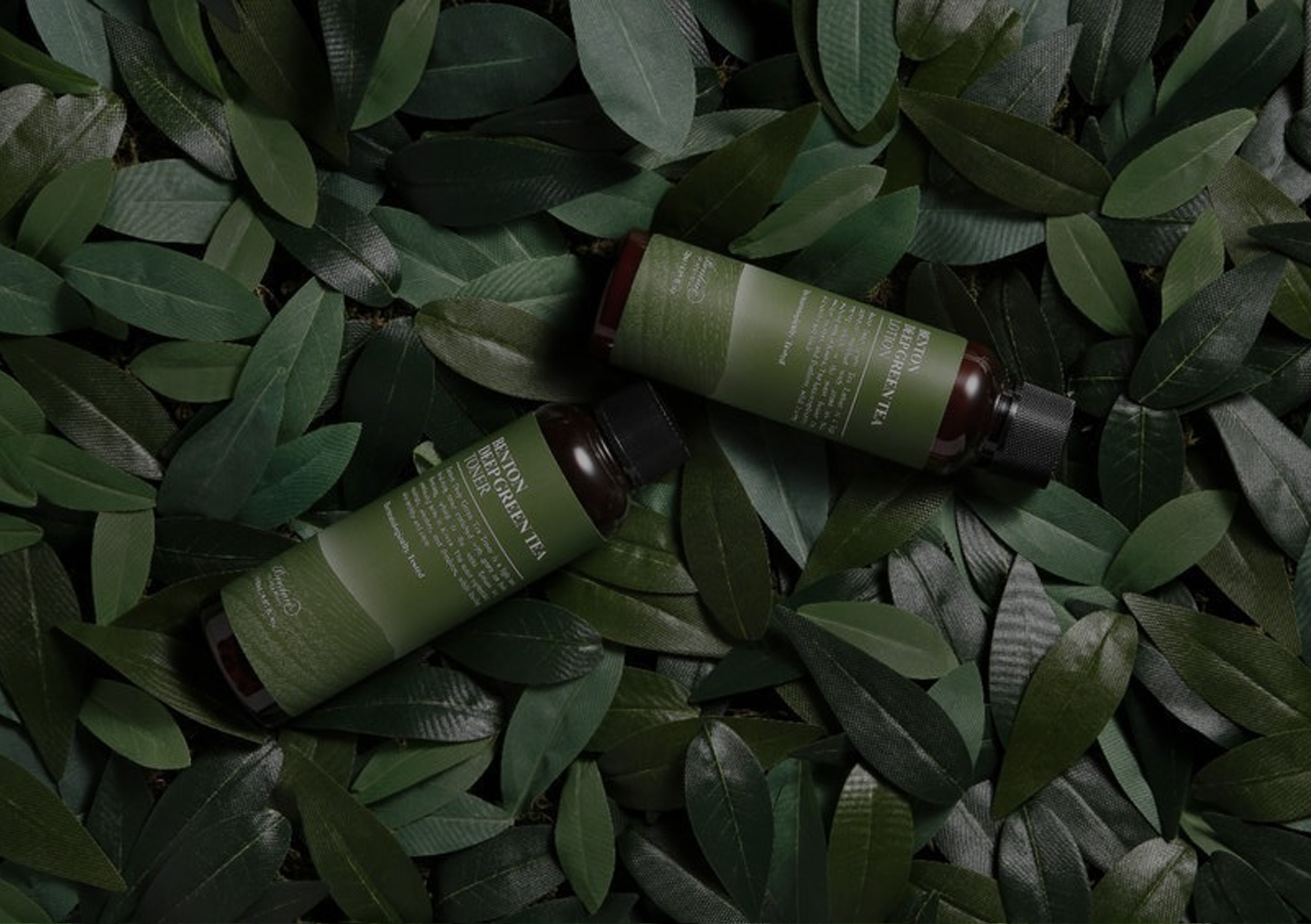 green-skincare-products-laying-on-leafs